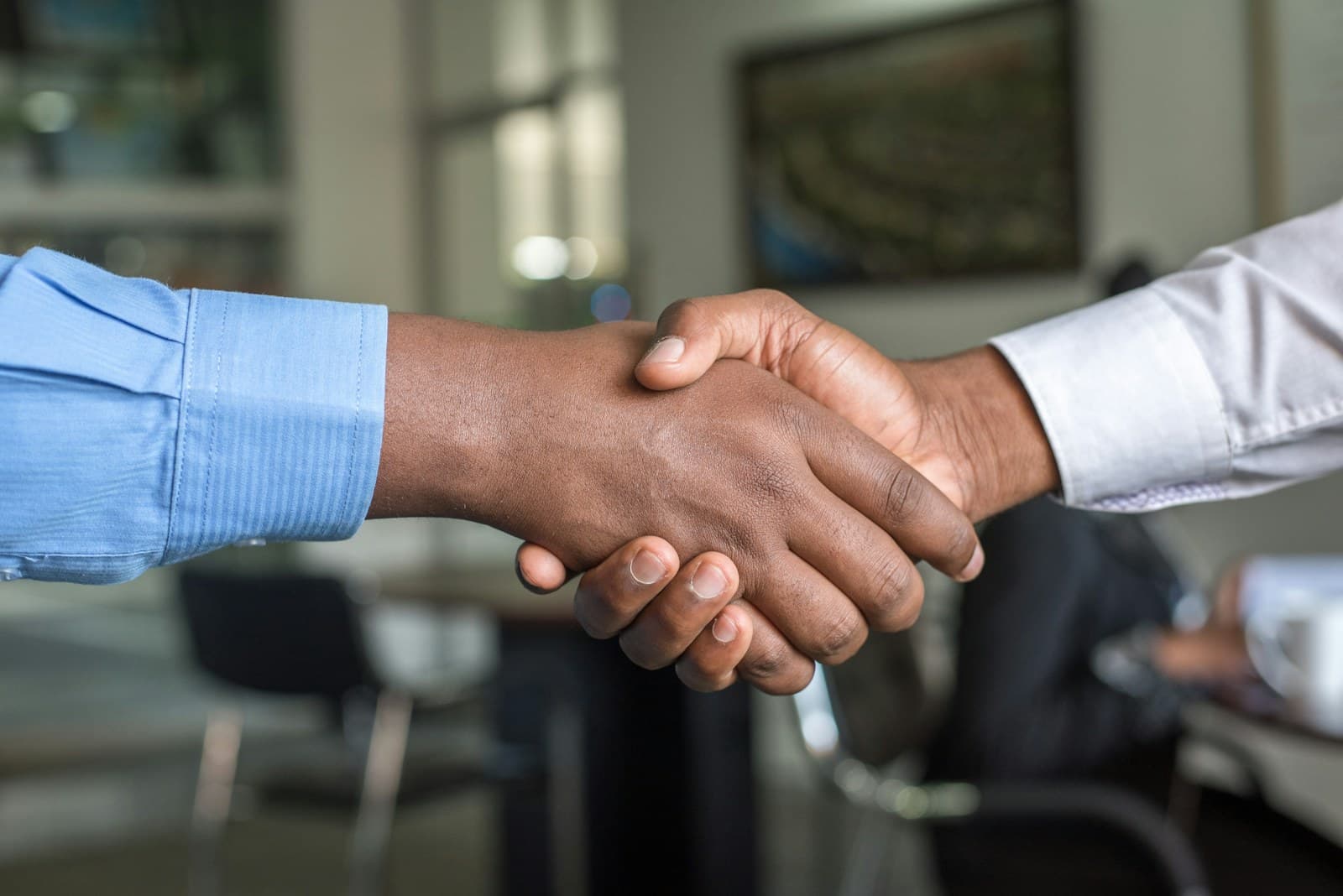 Customer and local business owner shaking hands